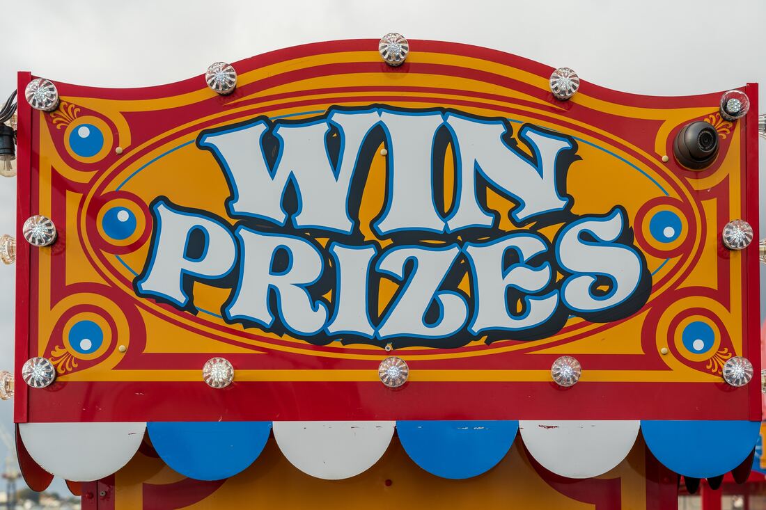 An image of a carnival booth sign that reads 